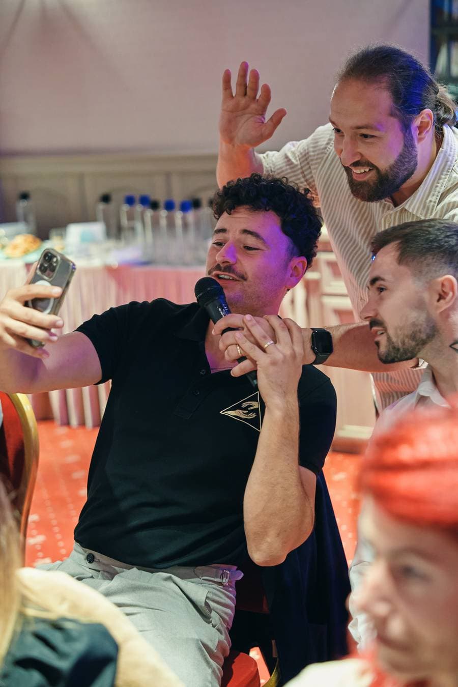 Participanți care își fac un selfie cu microfonul